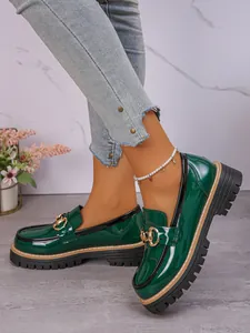 Dark green patent leather loafers with gold horsebit and chunky platform sole