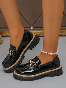 Black patent leather platform loafers for women with gold chain buckle detail