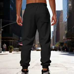 Rear view detail of black heavy fleece joggers for men in an urban street setting
