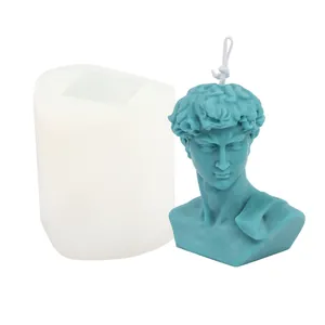 Detailed close-up showing a white David bust silicone mold beside a teal scented candle