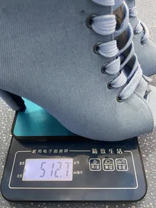Close-up of light blue lace-up peep toe sandals being weighed on a digital scale