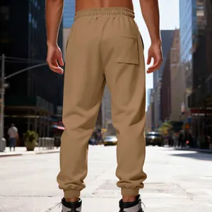Back view detail of men's khaki heavy fleece joggers in an urban city street setting