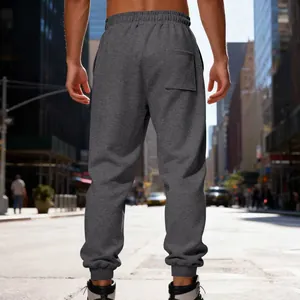 Back view of men's heavy fleece sweatpants in dark grey featuring ribbed elastic cuffs