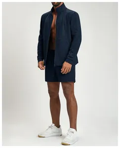 Detailed view of men's dark blue knitted athletic jacket and matching shorts set.