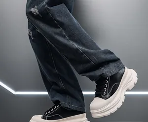 Detailed view of men's black sneakers with a 10cm thick platform white sole