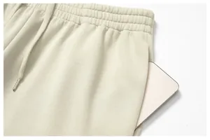 Close-up detail of men's jogger pants showing elastic waistband and deep side pocket