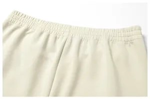 Detail shot of men's beige jogger pants featuring a comfortable elastic waistband