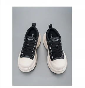Top-down view of men's black and cream chunky-soled height increasing sneakers shoes.