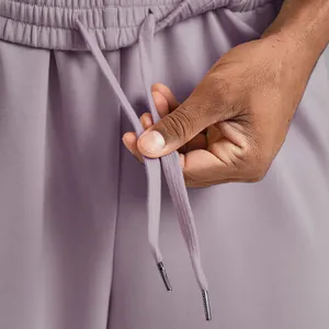 Detailed macro shot of drawstring and waistband on men's lilac sport joggers