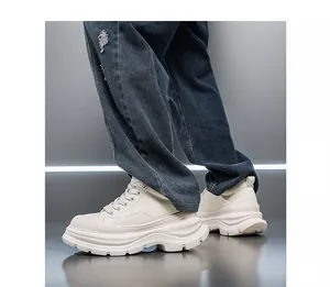 On-model detail shot of cream men's height increasing chunky sneakers with 10cm sole