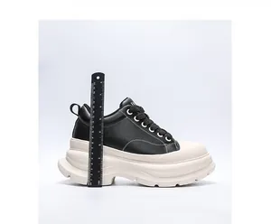 Detail view of mens elevator shoes with ruler showing 10cm chunky platform sole.