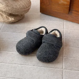 Macro view of grey wool felt children's winter shoes with warm soft faux fur lining