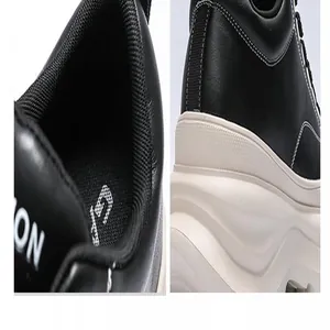 Close-up detail of black leather and thick white sole on men's elevator shoe