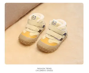 Detail of yellow winter toddler shoes with warm fleece lining and Velcro straps.