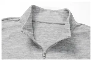 Close-up of grey men's athletic knit jacket featuring a high-neck quarter-zip collar