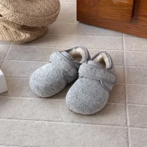Cozy grey wool felt slippers for kids with soft plush lining and velcro closure.