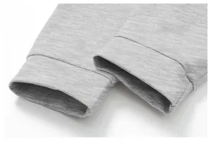 Close-up detail showing the high-quality knit texture and cuffs of a grey sports jacket.