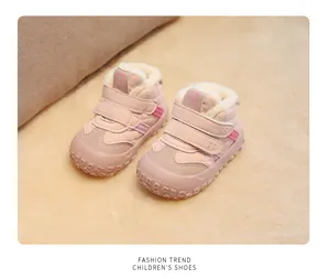 Detailed view of pink fleece-lined winter walking shoes for toddlers with secure velcro straps