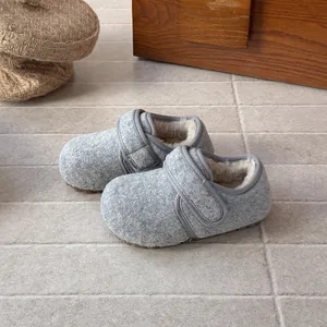 Detailed view of children's grey wool winter shoes with warm fleece lining and soft sole