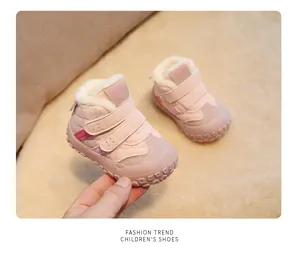 Close-up detail of pink fleece-lined infant winter walking shoes with warm quilted texture