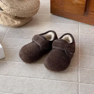 Top view of brown wool children's shoes with fuzzy lining and Velcro straps.