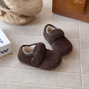 Detail view of brown winter wool Birkenstock shoes for kids with cozy warm fur lining