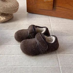 Detailed view of children's wool felt shoes with warm faux fur lining and velcro strap