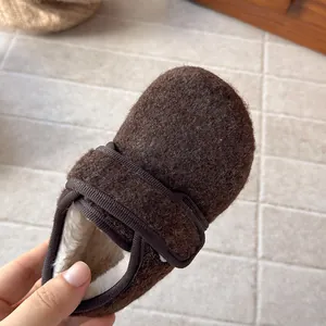 Close-up of cozy brown wool children's Birkenstock shoes with soft fleece lining
