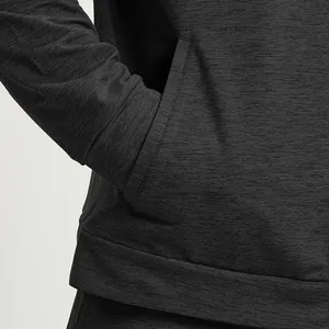 Detailed close-up of a men's dark grey heathered knit sports jacket with pocket view