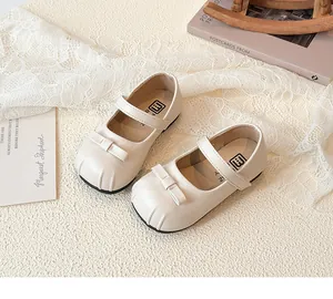 Elegant cream white girls' Mary Jane leather shoes with delicate bow detail and strap