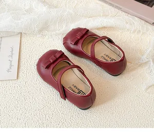 Elegant burgundy girl's Mary Jane leather shoes featuring a sweet bow and secure strap closure