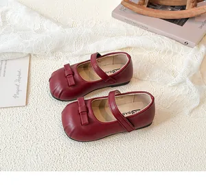 Detailed view of red leather Mary Jane shoes for girls featuring a cute bow accent