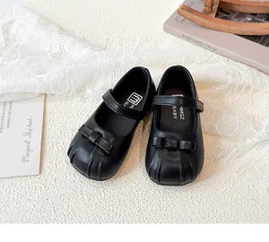 Top view of black girls' Mary Jane shoes with bow detail and scalloped toe design