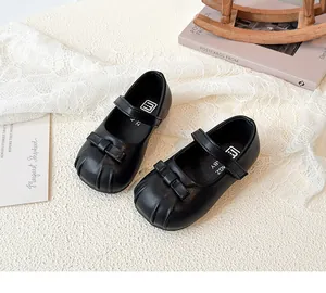 Classic black Mary Jane shoes for girls featuring cute bow and soft matte leather finish.