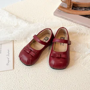 Classic red leather Mary Jane shoes for little girls with bow detail and strap closure