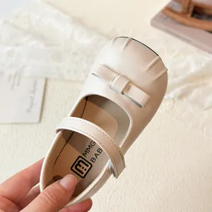 Elegant off-white girls princess dress shoes with bow detail and velcro strap closure