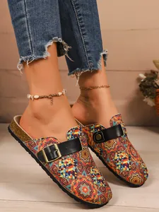 Detailed view of colorful bohemian printed closed-toe mules with adjustable buckle strap.