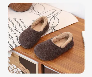 Close-up view of brown plush lined warm winter loafers featuring fuzzy interior and soft sole