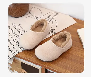 Close-up of warm beige fleece-lined slip-on mules, detail of soft winter home slippers
