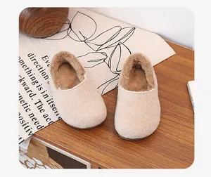 Premium beige fleece-lined mules with soft plush interior on a rustic wooden table