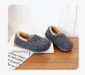 Detailed close-up showing the warm and soft plush lining inside gray felt mule slippers.