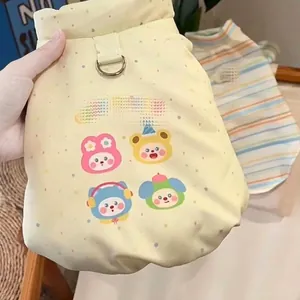 Detailed view of yellow pet winter jacket with cute cartoon prints and leash D-ring