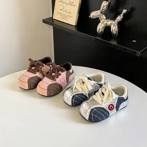 Detailed view of color-blocked kids sneakers in pink and denim silver finish