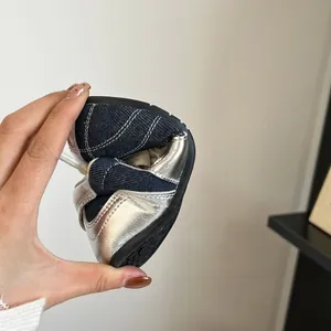 Detail showing the soft and flexible sole of the denim patchwork baby trainer shoes.
