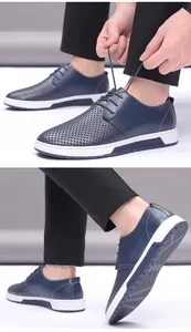Close-up detail view of navy blue perforated breathable men's casual leather shoes with laces