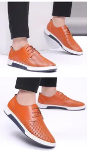 Detail view of men's breathable brown perforated leather casual shoes with white sole