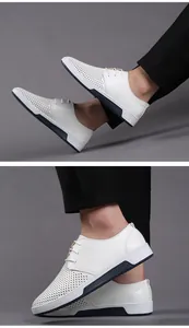 Close-up detail of white perforated leather men's casual shoes with breathable mesh design