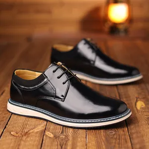 Close-up of black glossy leather Derby shoes with stylish two-tone thick soles.