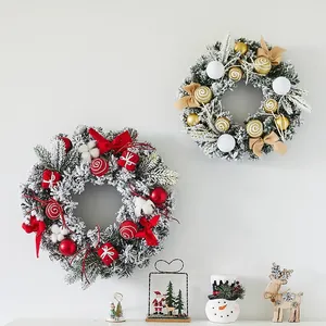 Decorative flocked Christmas wreaths with red and gold ornaments for festive wall display