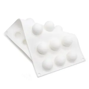 Close-up of a white 15-cavity round silicone mold for chocolate and cake pearls.